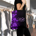 Purple roses black monogrammed tote bag<br><div class="desc">Elegant and chic Purple colored roses on a black colored background. Feminine and sophisticated.  Template for your monogram. (remove with your back-space key if you want it without text) Light Purple colored letters.</div>