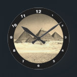 Pyramids & Desert, vintage Cairo / Ancient Egypt Round Clock<br><div class="desc">CLOCKS - Ancient Pyramids in Egypt vintage art. View on all of the pyramids in line is highlighting magnificence of the area. Top of Great Pyramid is still covered with flat decorative stone desks and let us imagine, what amazing view it must have been in the times of their peak....</div>