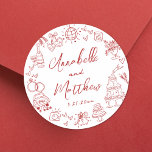 Quirky Hand Drawn Red Whimsical Wedding Classic Round Sticker<br><div class="desc">Personalised Hand-Drawn Quirky Red Wedding Stickers. These fun and playful round wedding stickers feature quirky doodle illustrations surrounding the edges, all in a vibrant red theme. Elements like a champagne tower, wedding cake, disco ball, hearts, wedding bells, rings, cameras, and more create a whimsical and celebratory vibe. The bride and...</div>