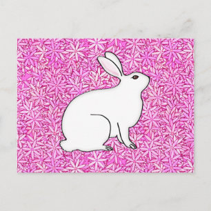 Rabbit on a bed of spring flowers postcard