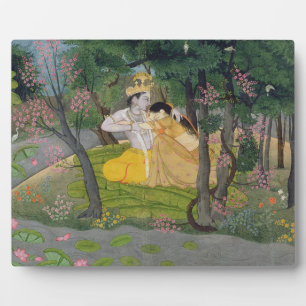 Radha and Krishna embrace in a grove of flowering Plaque