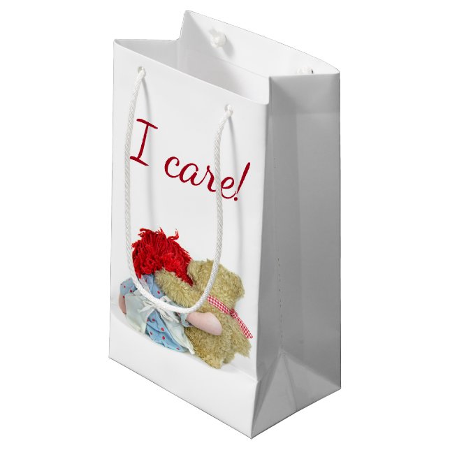 rag doll and teddy bear hug on white small gift bag (Front Angled)