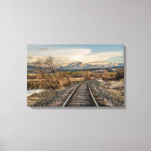 Railroad Tracks Curving Before the Mountains Canvas Print