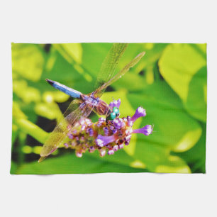 Rainbow coloured Dragonfly  on a purple pink flowe Tea Towel