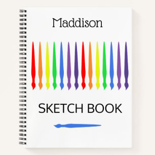 Rainbow of paint brushes, sketchbook, your name notebook