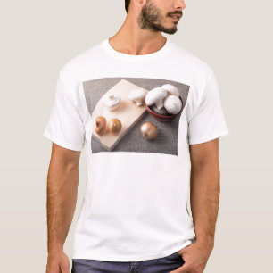 Raw champignon mushrooms and onions on the table T-Shirt