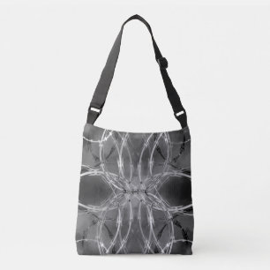 Razor wire pattern against dark clouds crossbody bag