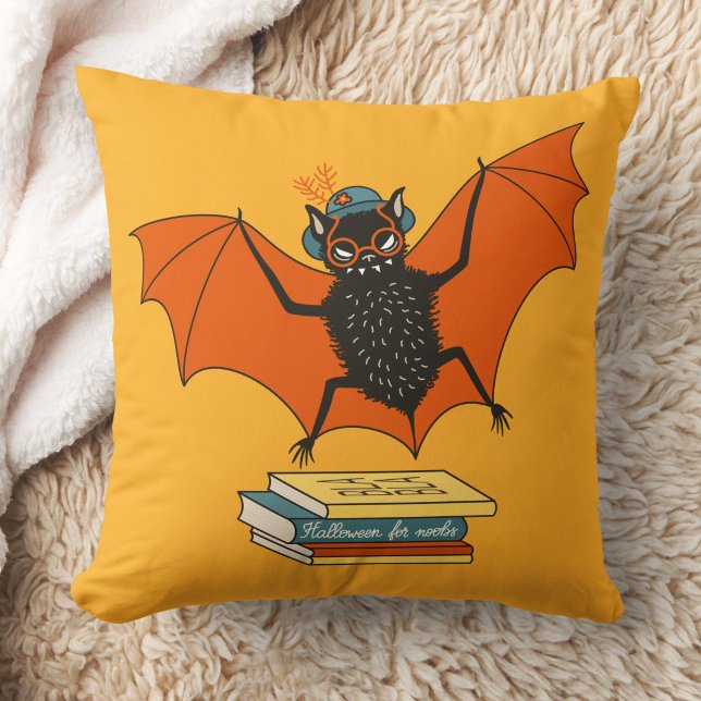 Reading Bat | Whimsical Librarian with Books Cushion (yellow pillow with a funny cartoon bat librarian with eyeglasses and hat flying over books)
