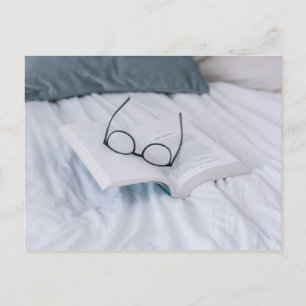 reading in bed white sheets postcard