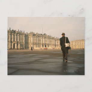 Rear view of a man walking in front of a palace, postcard