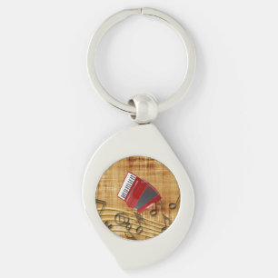 Red accordion, black notes, gold background key ring