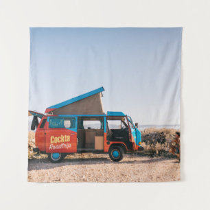 Red and blue vehicle beside man tapestry