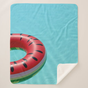 Red and green lifebuoy on swimming pool sherpa blanket