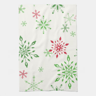 Red and Green Snowflakes on a white background Tea Towel