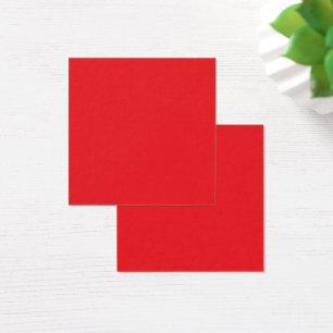 Red and orange crayons lying side by side on a whi