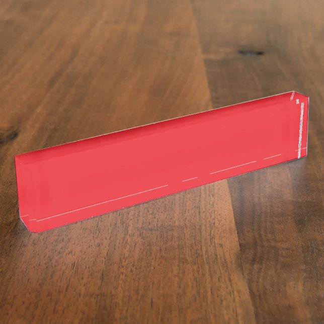 Red and orange crayons lying side by side on a whi nameplate (Side)