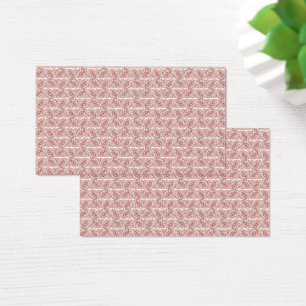 Red and pink textiles laid over a patterned rug wi