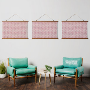 Red and pink textiles laid over a patterned rug wi hanging tapestry