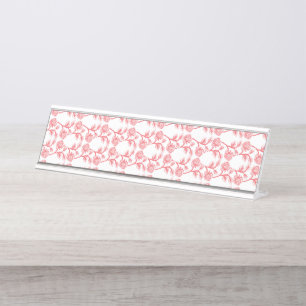 Red and pink wrapping paper featuring a repeating  desk name plate