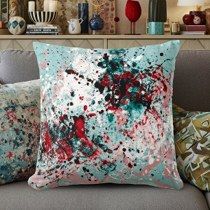 Red and teal splatters cushion