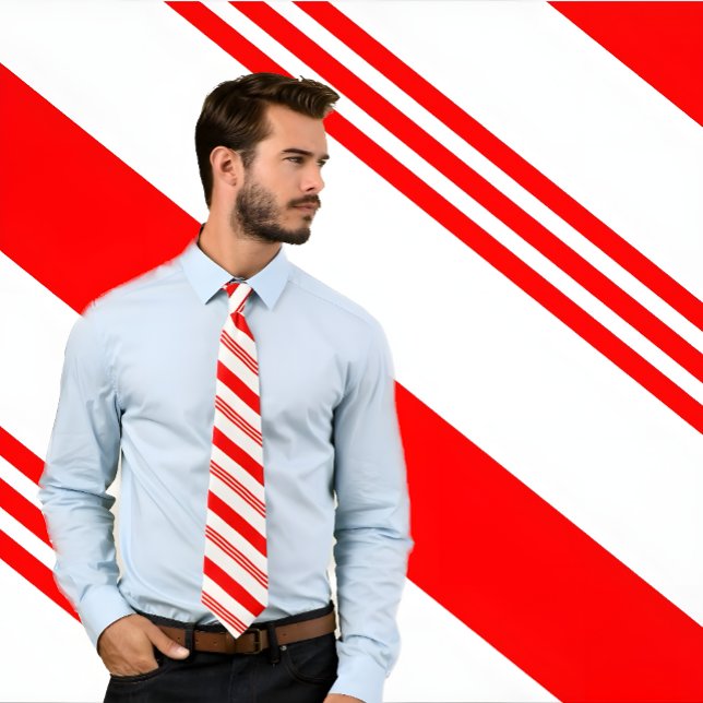 Red and White Candy Cane Tie (Man wears a candy cane striped, red and white, necktie. He stands against candy stripe background.)