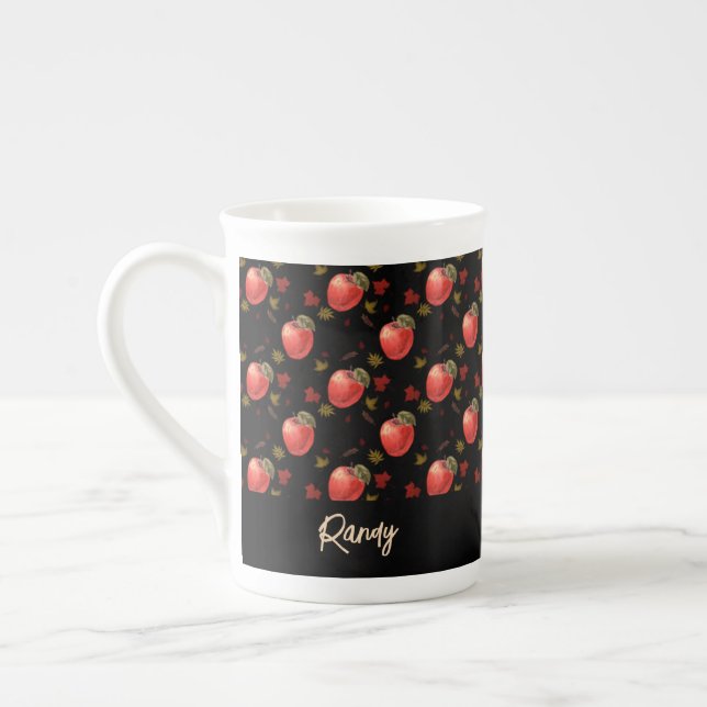 Red apples and leaves on black bone china mug (Left)