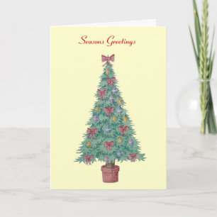 red bows and bells on decorated tree for christmas holiday card