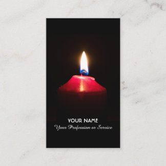 Red candle light illuminates the dark business card
