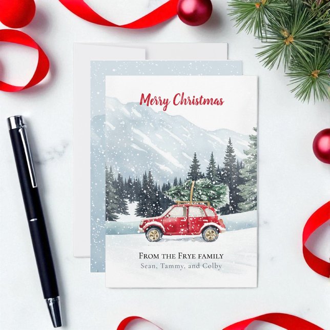 Red Car Christmas Tree Mountain Holiday Card  (Christmas holiday red car with Christmas tree on a snowy mountain top. Card is on marble countertop)
