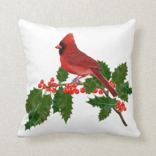 RED CARDINAL PERCHED ON HOLLY CUSHION