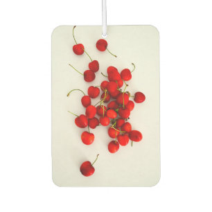 Red Cherries in Natural Light Lay on White Car Air Freshener