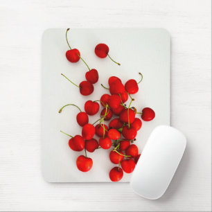 Red Cherries in Natural Light Lay on White Mouse Mat