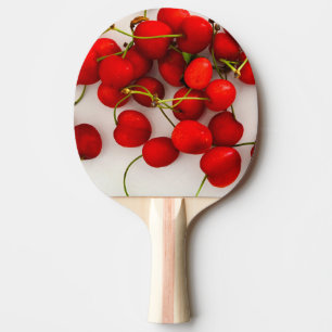 Red Cherries in Natural Light Lay on White Ping Pong Paddle