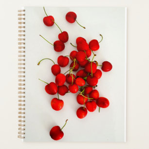 Red Cherries in Natural Light Lay on White Planner
