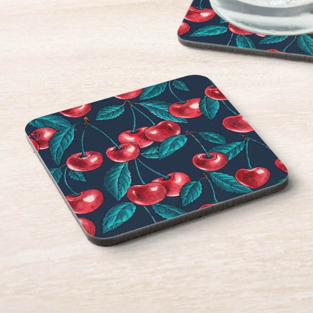 Red cherries on dark blue coaster (Left Side)