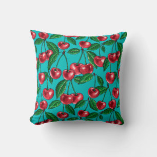 Red cherries on turquoise cushion
