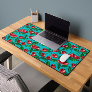 Red cherries on turquoise desk mat