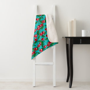 Red cherries on turquoise sherpa blanket