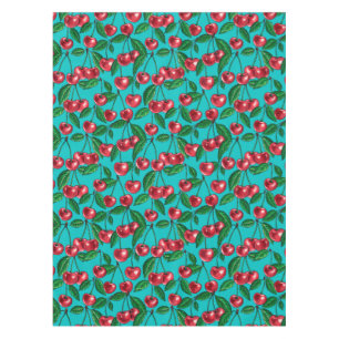 Red cherries on turquoise tablecloth