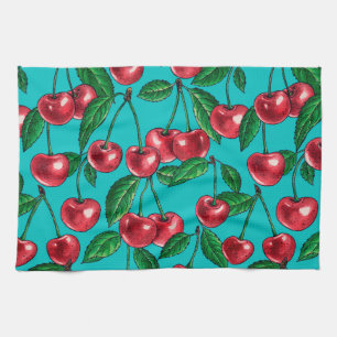 Red cherries on turquoise tea towel