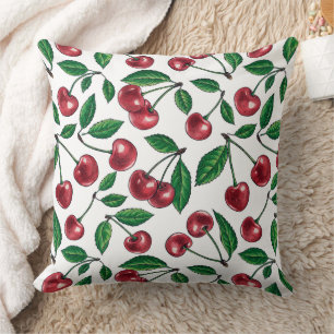 Red cherries on white cushion