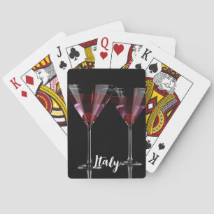 Red cocktails in martini glass with cherry playing cards