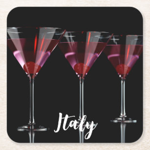 Red cocktails in martini glass with cherry square paper coaster