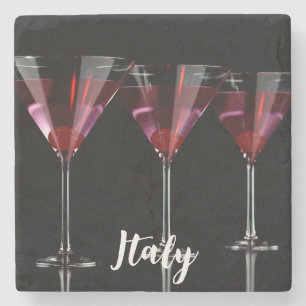 Red cocktails in martini glass with cherry stone coaster