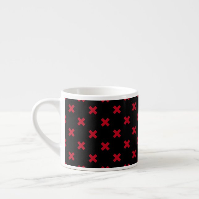 Red cross stitches on black espresso cup (Left)