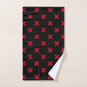 Red cross stitches on black hand towel