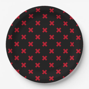 Red cross stitches on black paper plate