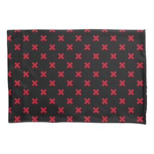 Red cross stitches on black pillowcase