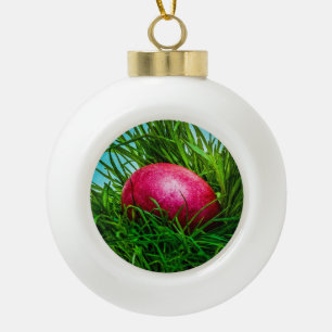 Red Easter egg in the grass Ceramic Ball Christmas Ornament