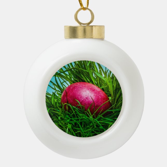 Red Easter egg in the grass Ceramic Ball Christmas Ornament (Front)